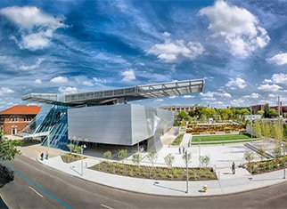 The Akron Art Museum and park with wispy clouds on a sunny day.