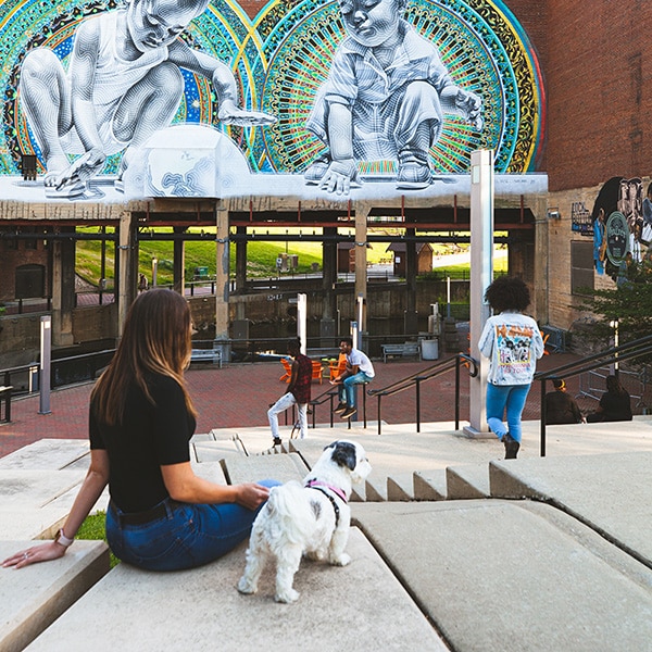 A woman sitting and relaxing with a dog at Lock 4