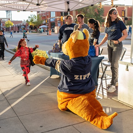 202_FallFest2024-cropped A man and women clink coffee cups