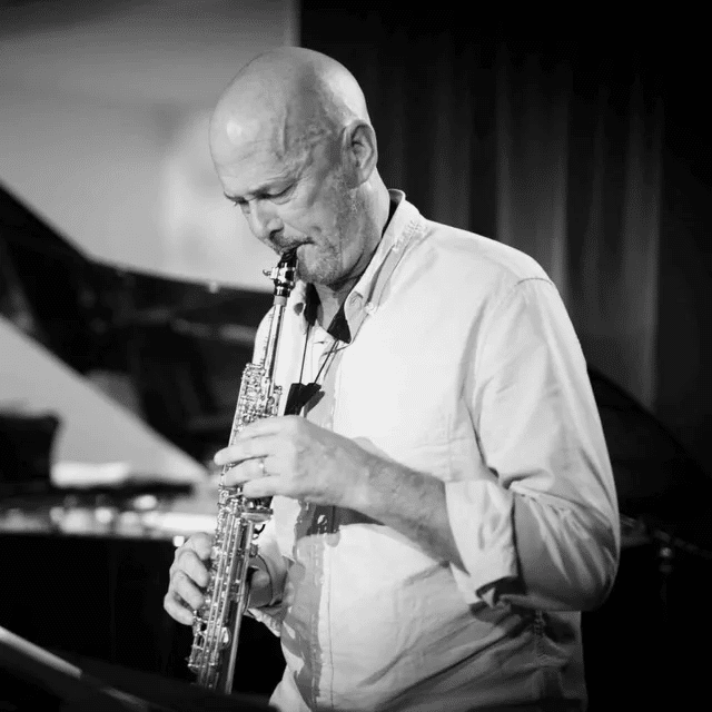 Black and white photograph of jazz musician David Bixler playing an alto saxophone
